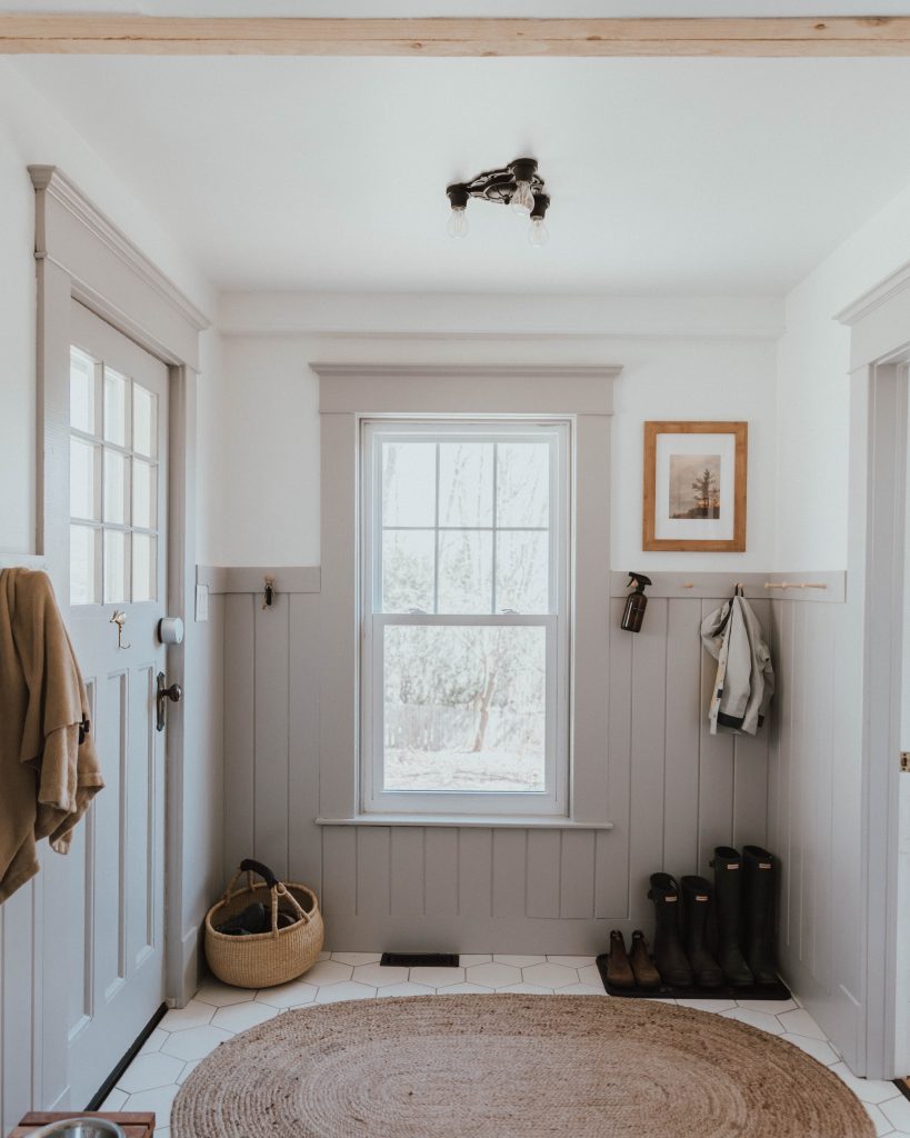 The Wild Decoelis | Our  Traditional Farmhouse Laundry and Mud Room | grey wainscotting and shaker peg rails