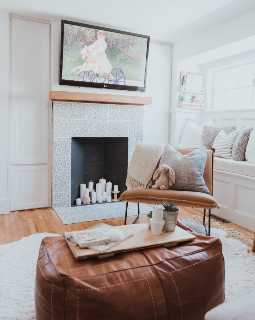 The Wild Decoelis | Our Cozy and Welcoming Family room | grey sectional, jute rug, shag sheepskin rug, leather ottoman, leather Mobilia ned chair, blanket ladder. fireplace with candles