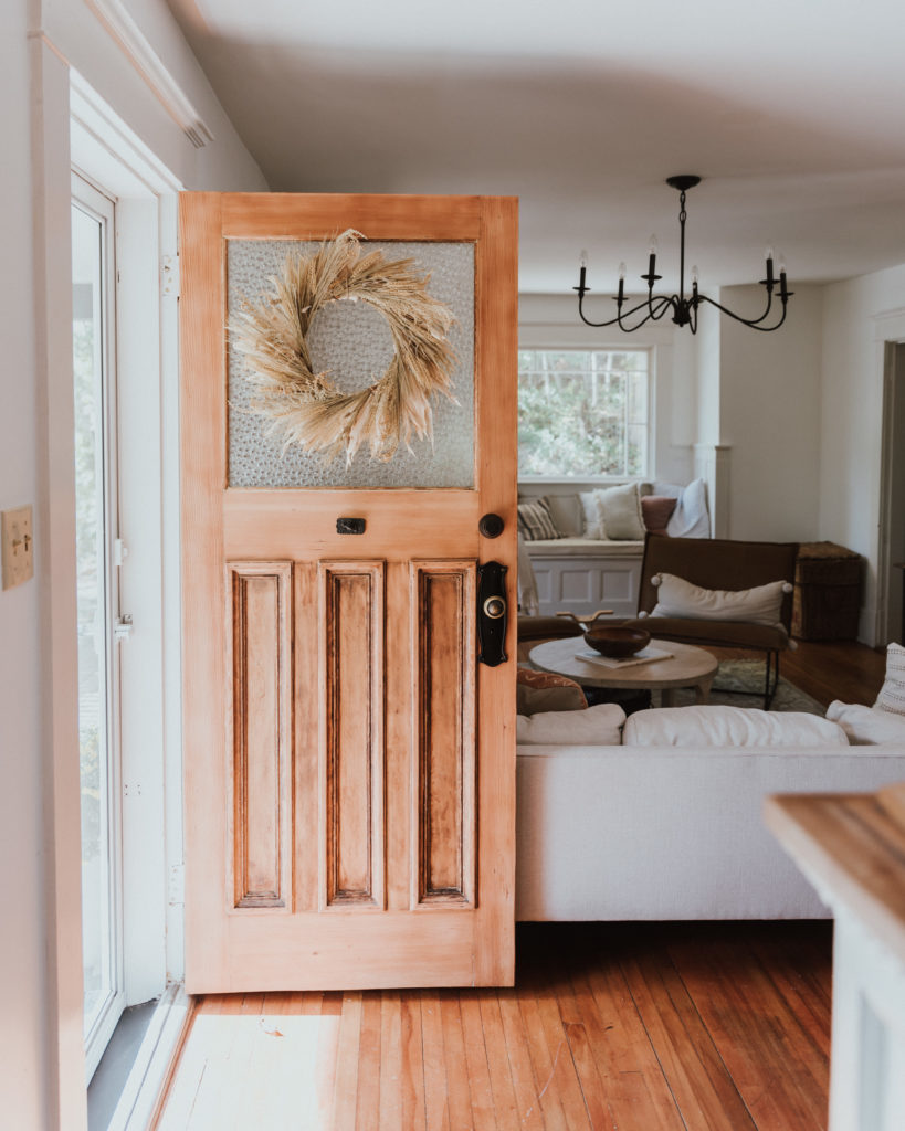 The Wild Decoelis | Fall Home Tour | stripped raw wood front door with fall wreath