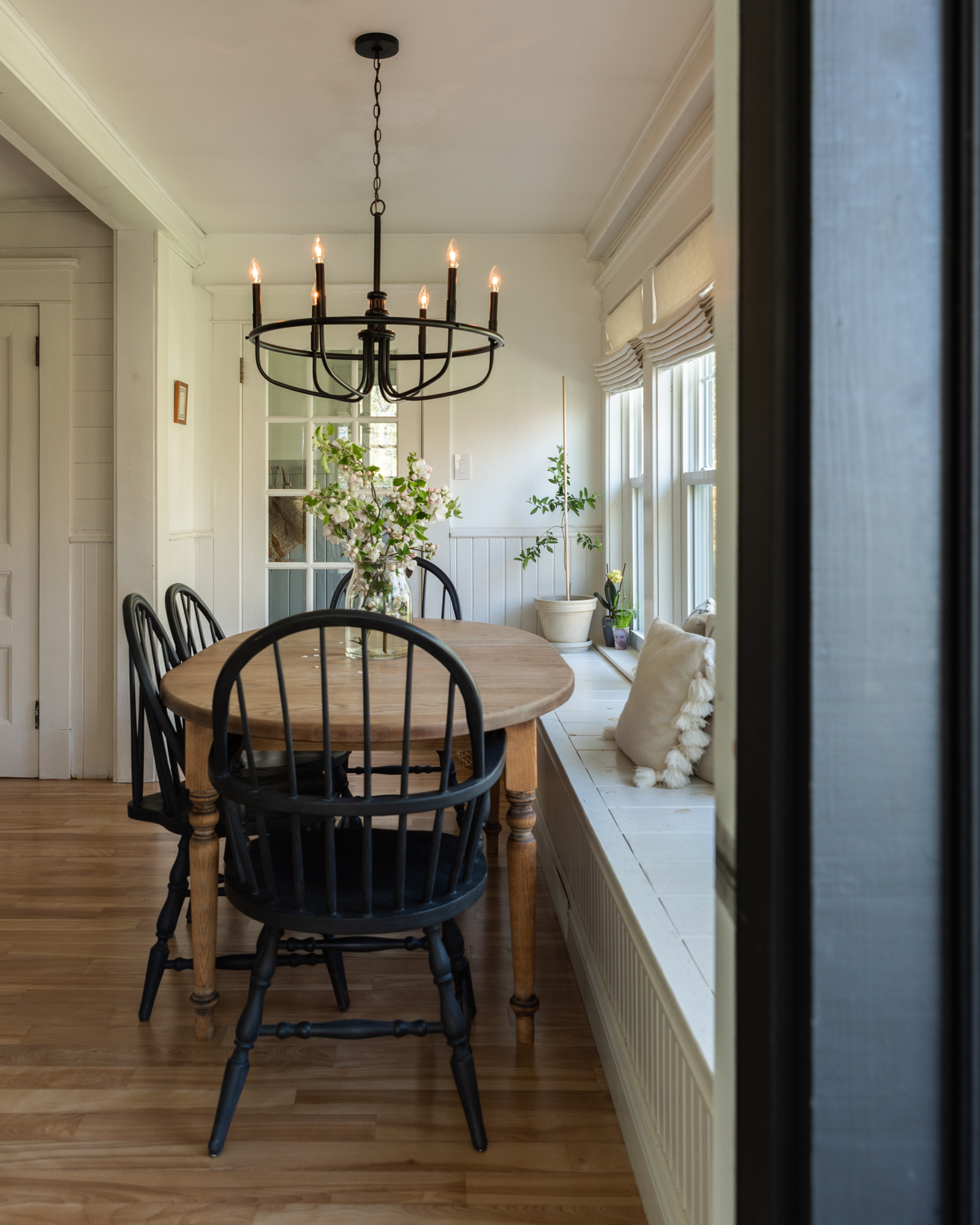 The Wild Decoelis | Lutron by Caseta| black windsor back chairs, antique oak table, black chandelier